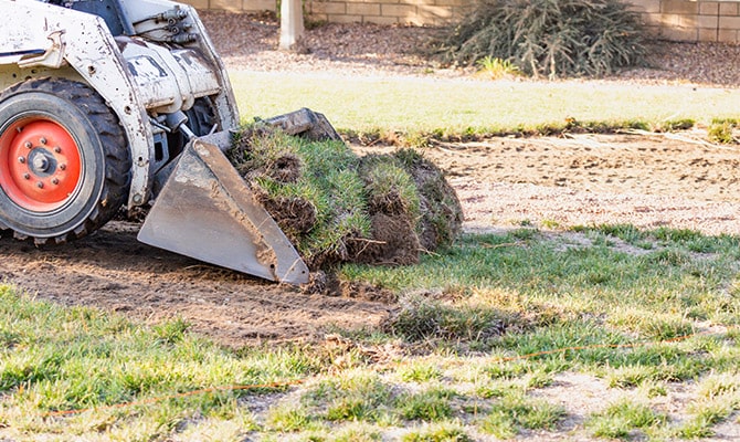 Mini excavator doing landscape grading